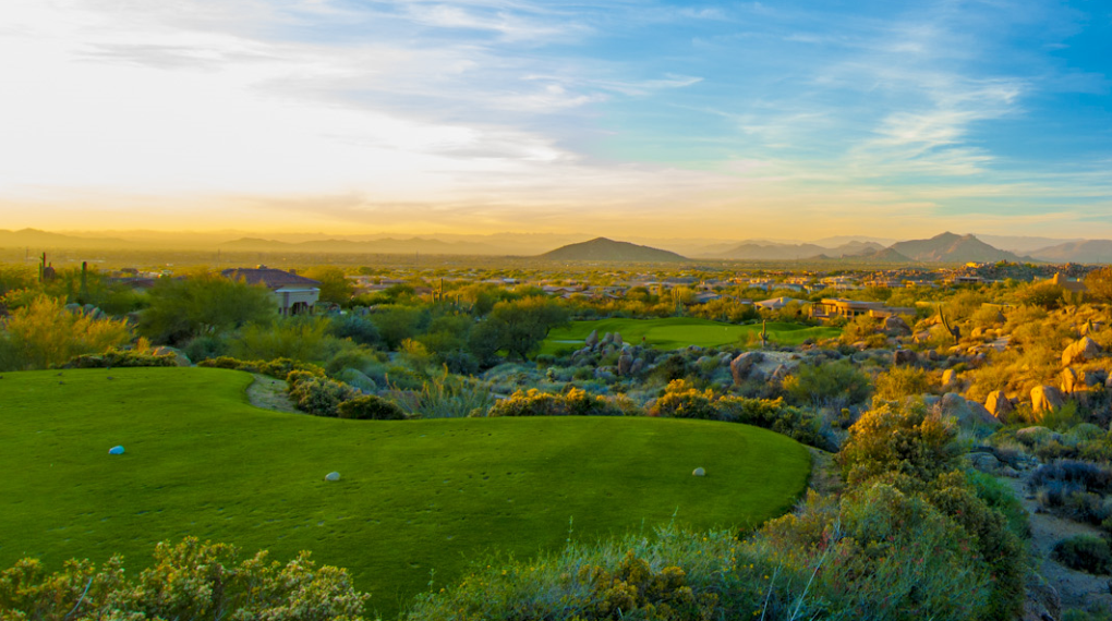 Sunrise on the 16th hole elevated tee box with green below making for a tough par 3 