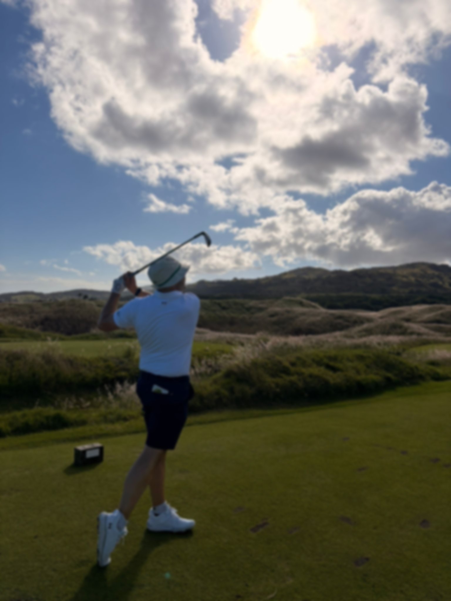 Golfer hitting a ball on a golf course in Mauritius