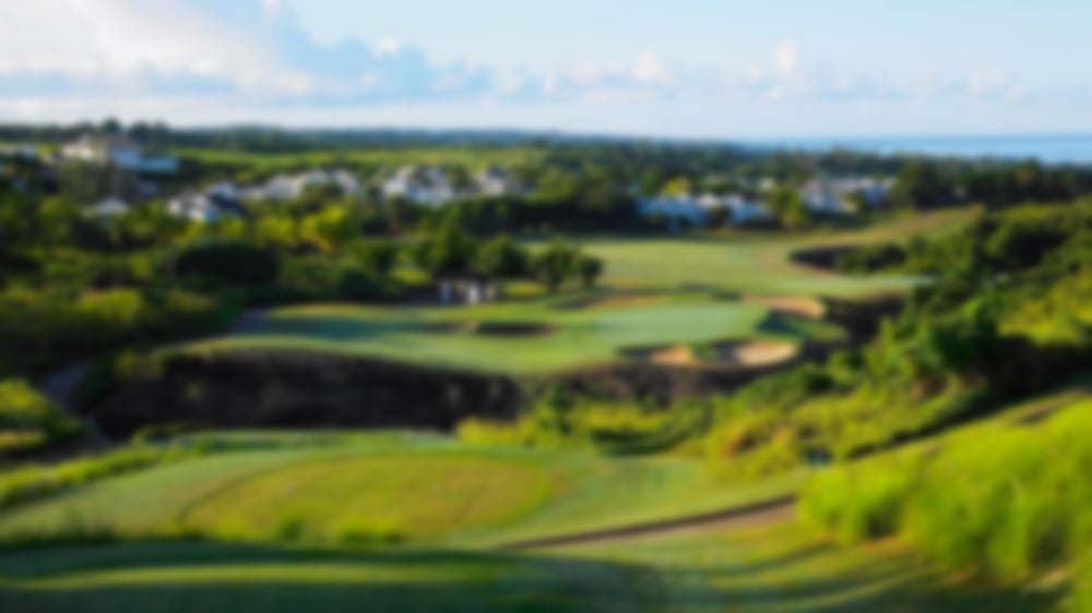 Upward view of a par 3 at Westmoreland, overlooking the distant houses and horizon.