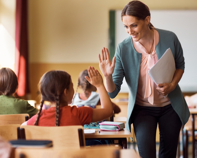 Teacher giving a student a high five