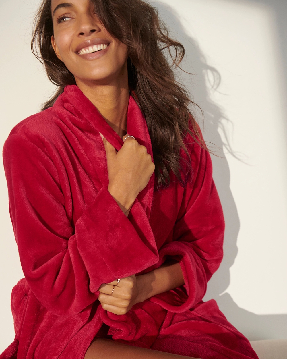 Soma<sup class=st-superscript>®</sup> model wearing a red plush women’s pajama robe.