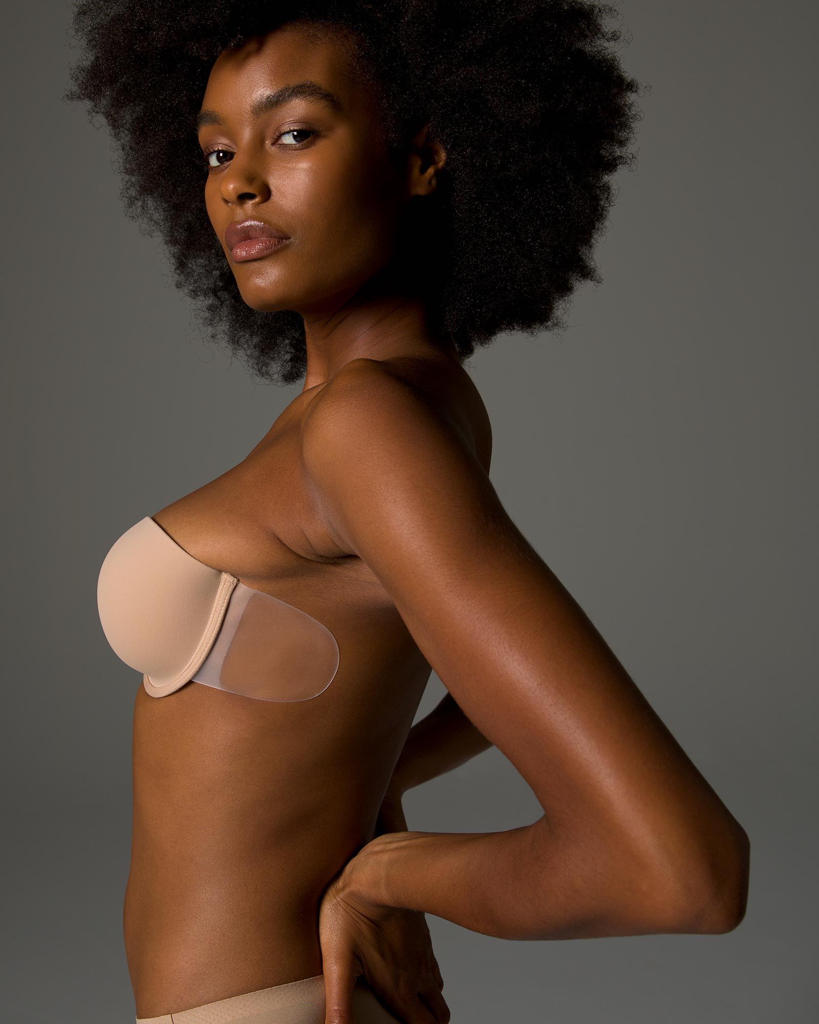 Soma<sup class=st-superscript>®</sup> women’s model wearing a nude adhesive backless, strapless bra.