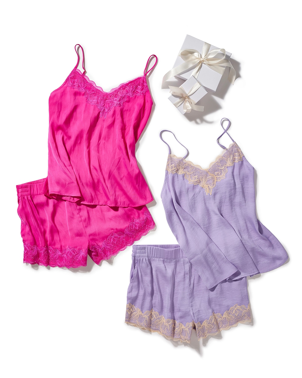 Soma<sup class=st-superscript>®</sup> laydown of pink and purple lace-trim satin camisole and matching lace-trim satin shorts, and white gift-wrapped boxes.
