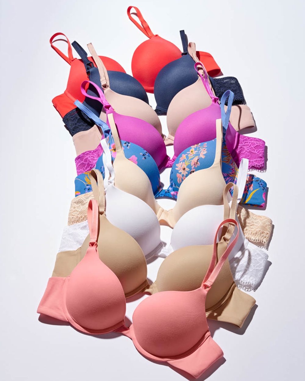 Soma<sup class=st-superscript>®</sup> laydown of red, navy, nude, pink, blue floral, and white push-up bras.