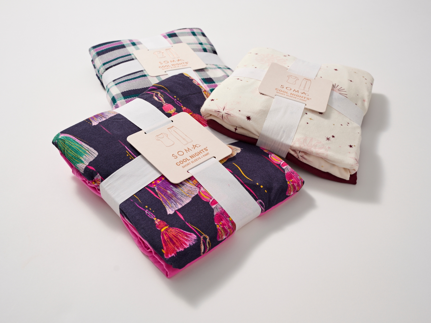 Soma<sup class=st-superscript>®</sup> packaged sleepwear sets in a variety of plaid and festive patterns. 