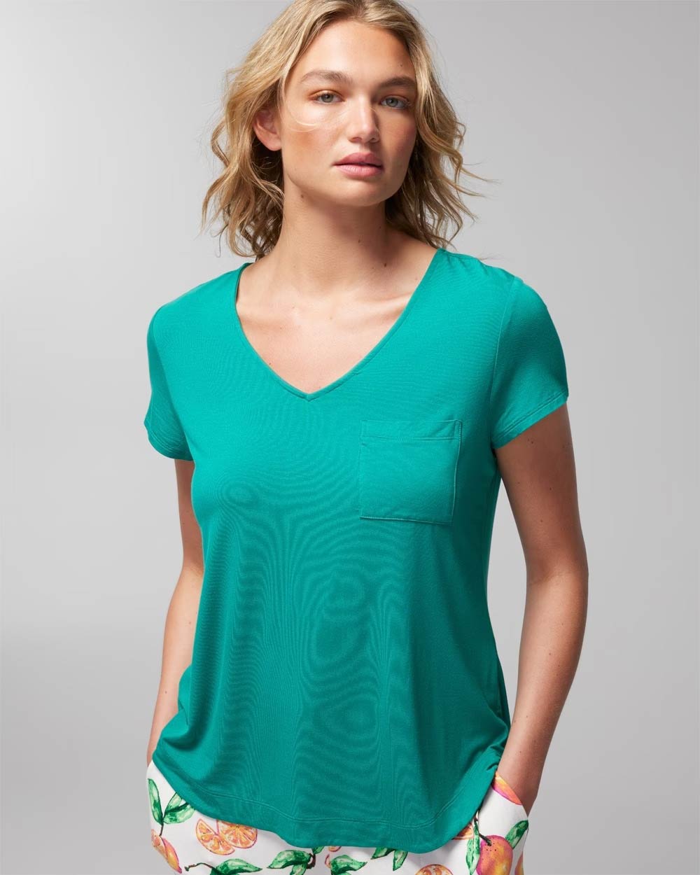 Soma<sup class=st-superscript>®</sup> women’s model wearing a teal green v-neck short-sleeve T-shirt.