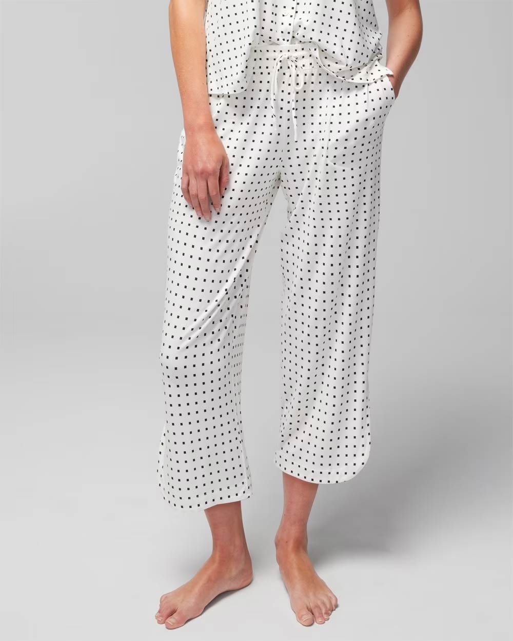 Soma<sup class=st-superscript>®</sup> women’s model wearing white and black polka dot cropped pajama pants.