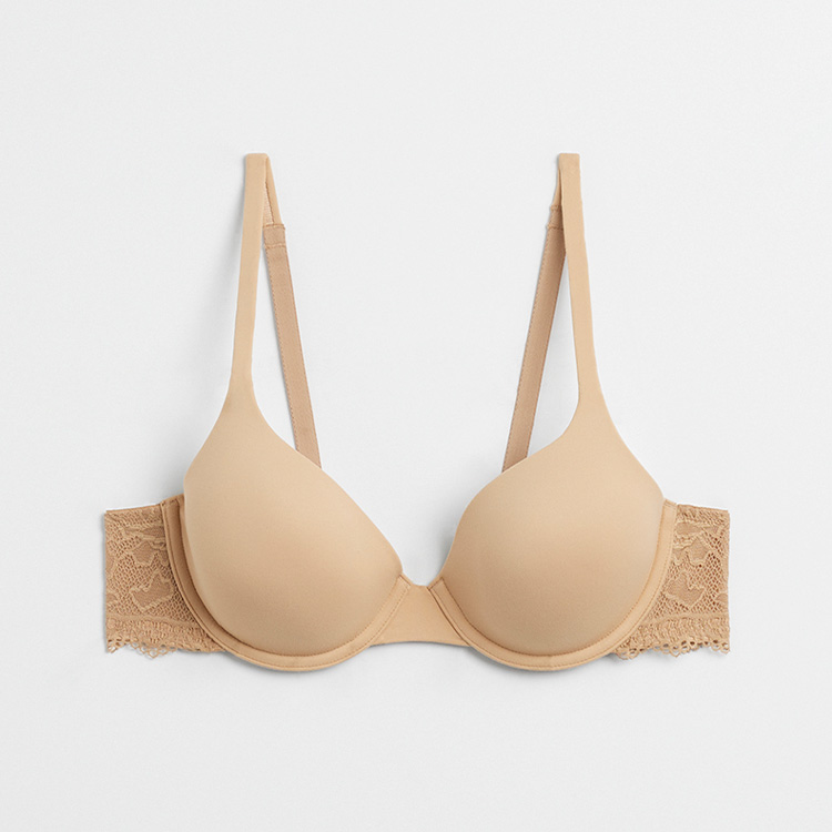 Soma<sup class=st-superscript>®</sup> laydown of a nude lace-trimmed demi bra.