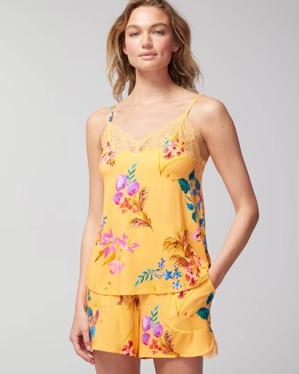 Soma<sup class=st-superscript>®</sup> women’s model wearing a yellow lace-trimmed floral cami with matching shorts.