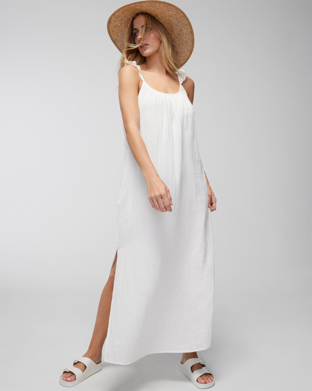 Soma<sup class=st-superscript>®</sup> model wearing a white maxi swim cover-up, straw wide-brim sunhat, and white slide sandals.