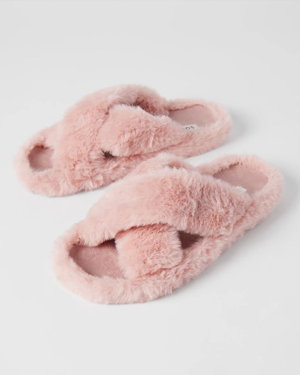 Soma<sup class=st-superscript>®</sup> laydown of pink fuzzy crossover slide slippers.
