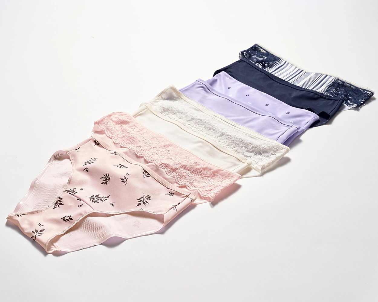 Soma<sup class=st-superscript>®</sup> laydown of pink, white, purple, and blue panties in solids and prints cascading in a row.
