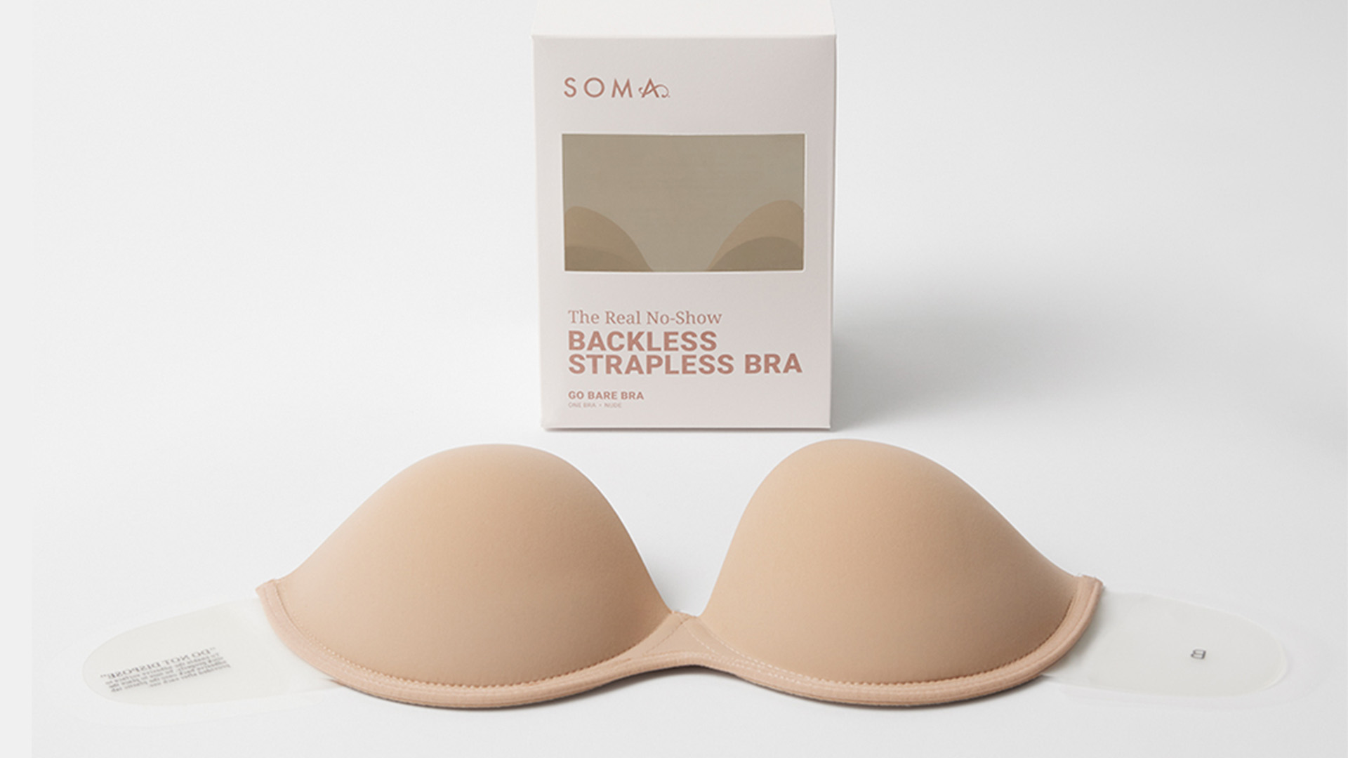 Soma<sup class=st-superscript>®</sup> laydown of nude adhesive backless bra in front of product packaging.