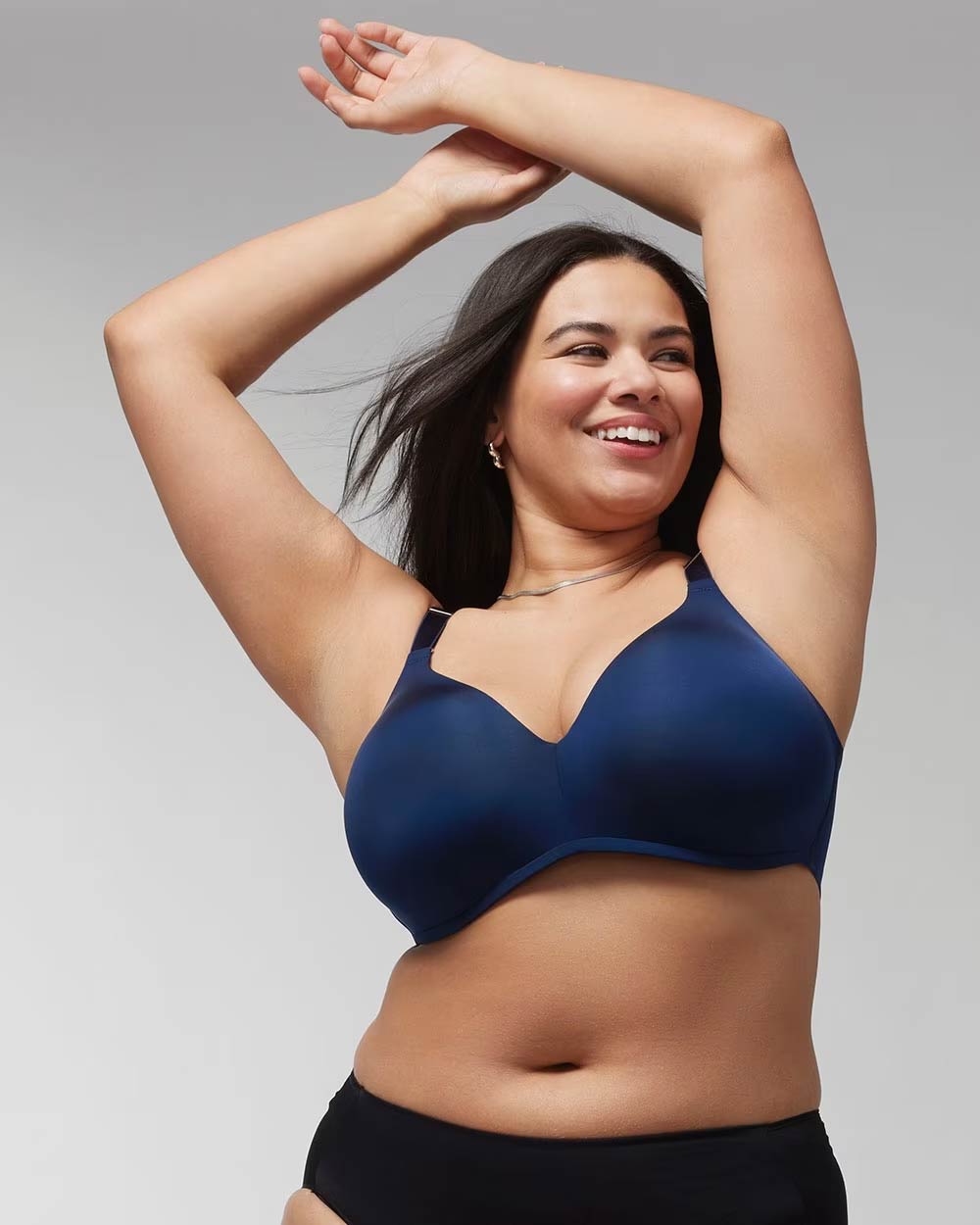 Soma<sup class=st-superscript>®</sup> women’s model wearing a navy blue bra and panties, and a silver chain necklace.