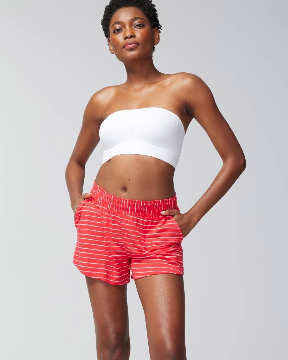 Soma<sup class=st-superscript>®</sup> women’s model wearing red and white striped shorts and a white bandeau bra.