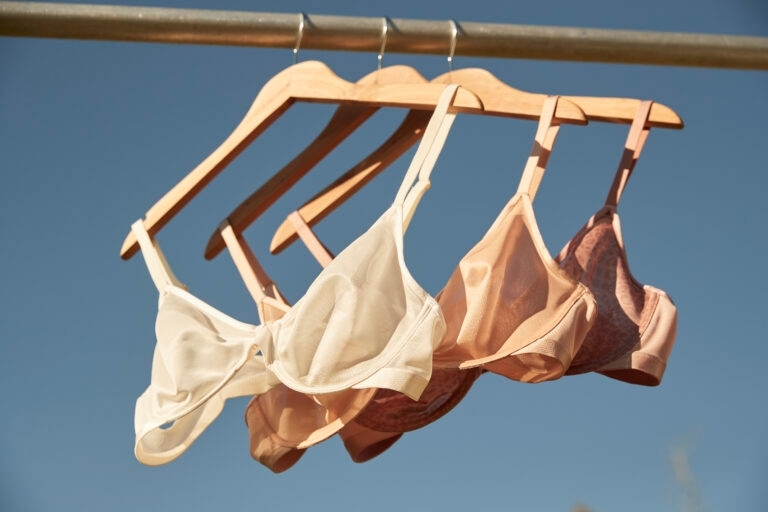 Soma<sup class=st-superscript>®</sup> nude unlined bras hanging on a rack.