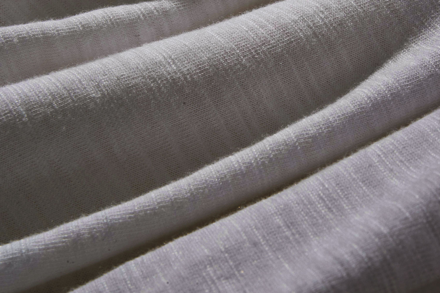 A close-up image of draped grey rayon fabric.