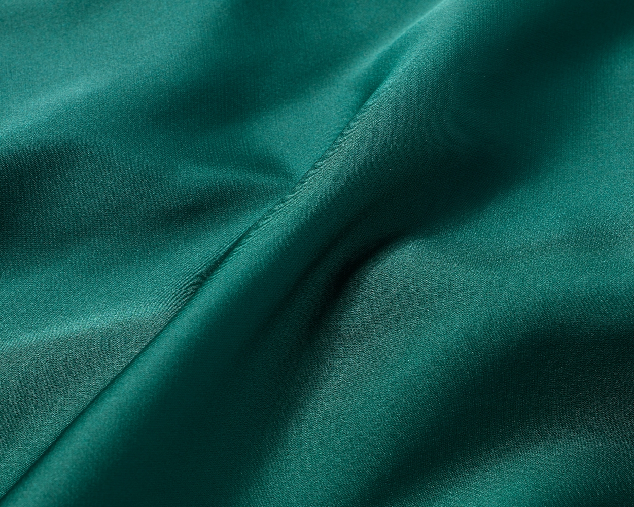 Close-up shot of dark green Soma<sup class=st-superscript>®</sup> satin fabric.