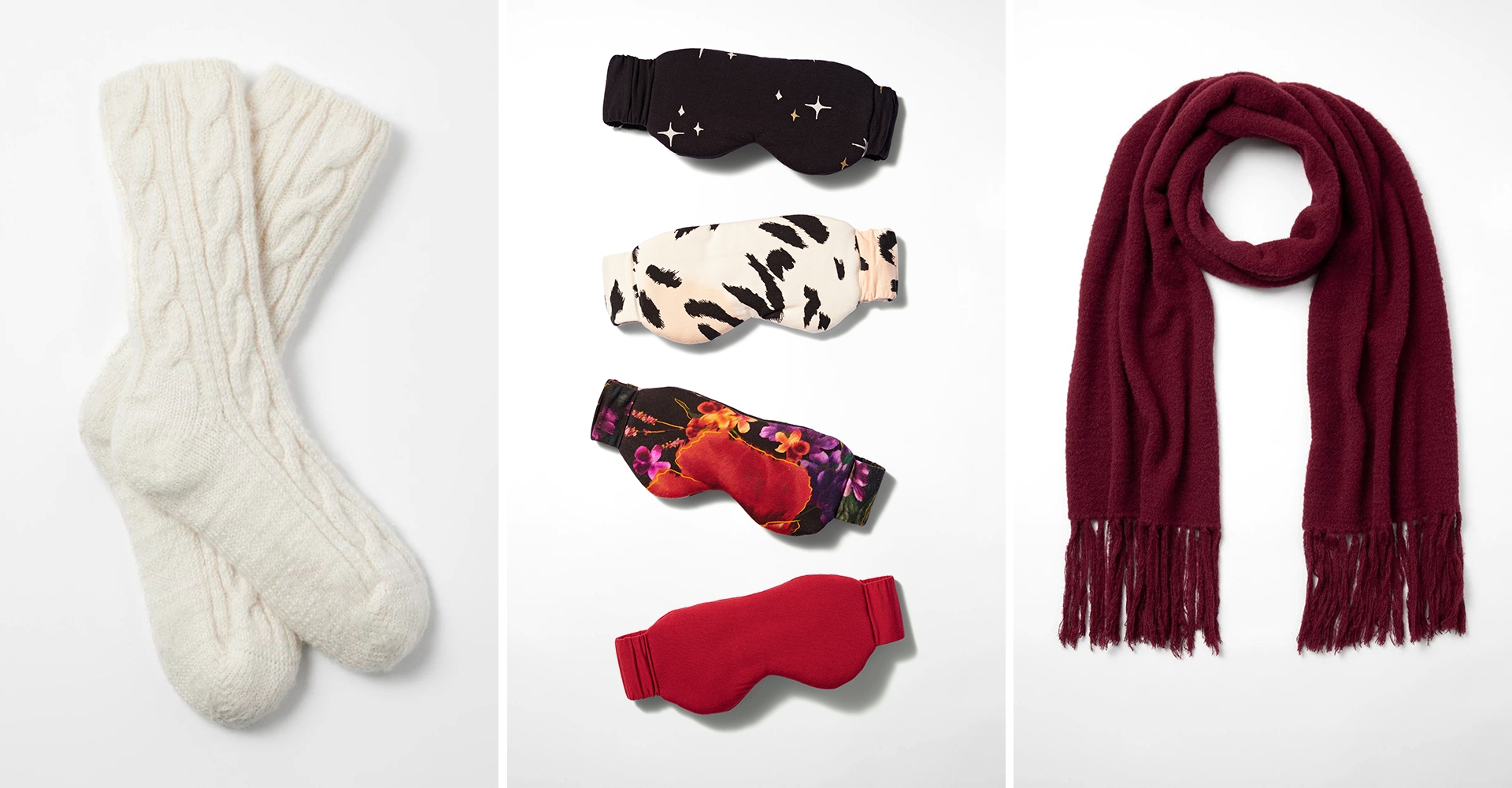Soma<sup class=st-superscript>®</sup> laydown of off-white cable knit socks, patterned + solid sleep masks, and burgundy tassel scarf.