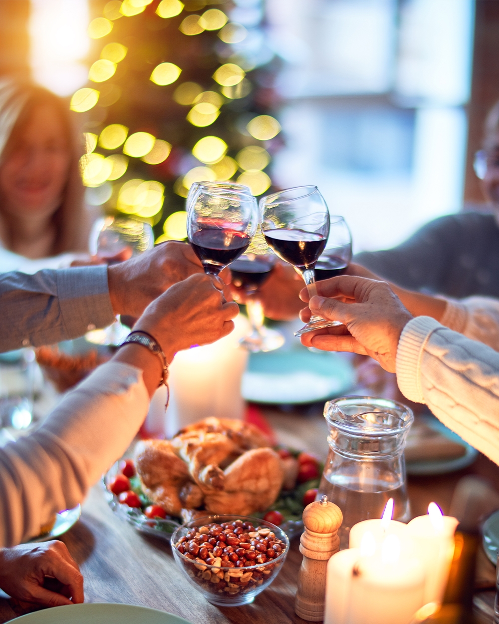 Self-Care-Six hands holding a glass of red wine cheersing over top of a holiday dinner tablescape.-for-the-Holidays_Single_1000x1250_14.jpg