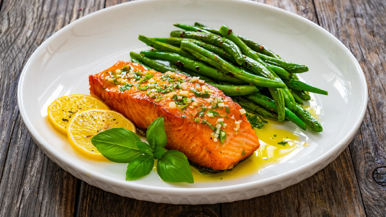 a photo of broiled salmon with lemon herb butter and asparagus