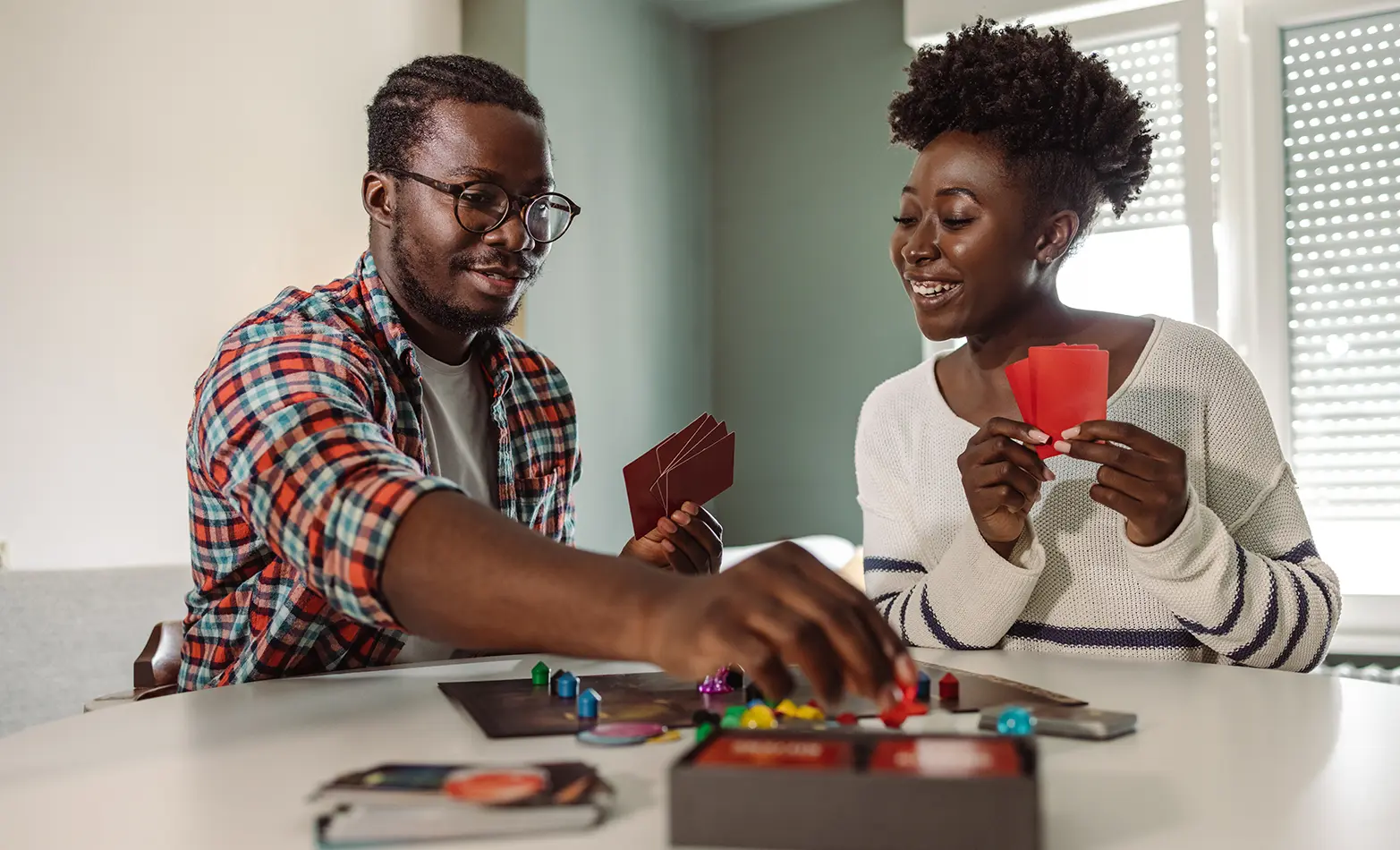 A photo of a couple playing a board game.