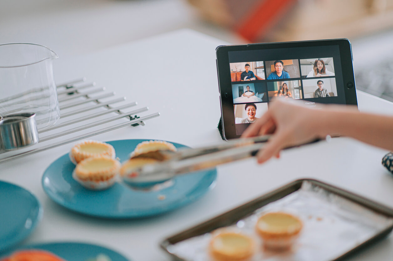 Kitchen tongs on food during video call.