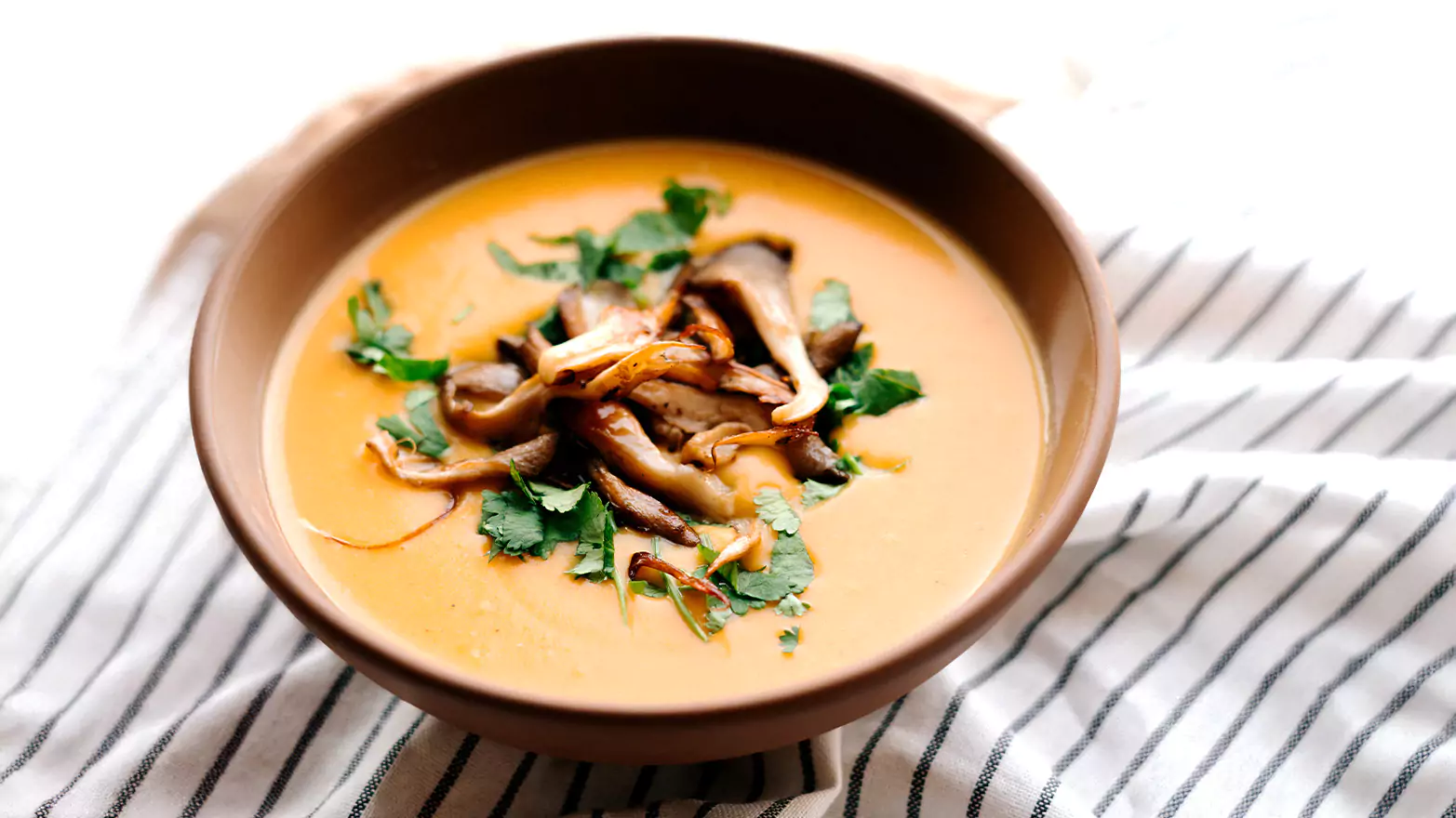 A bowl of golden mushroom soup.
