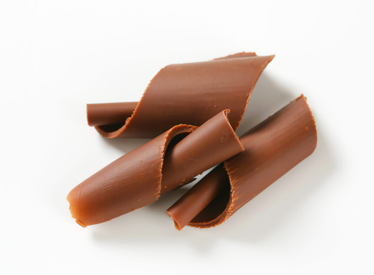 Chocolate curls on white background.