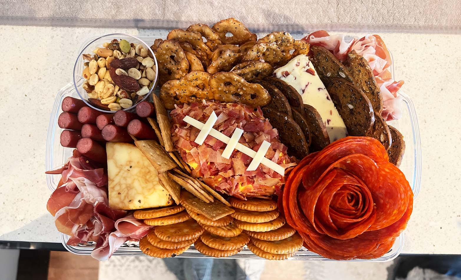 a snack board featuring a pepperoni football
