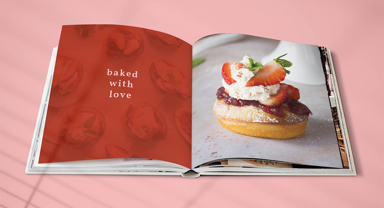 A photo of a cookbook, laid flat and opened to a page with a photo of a strawberry dessert on it.