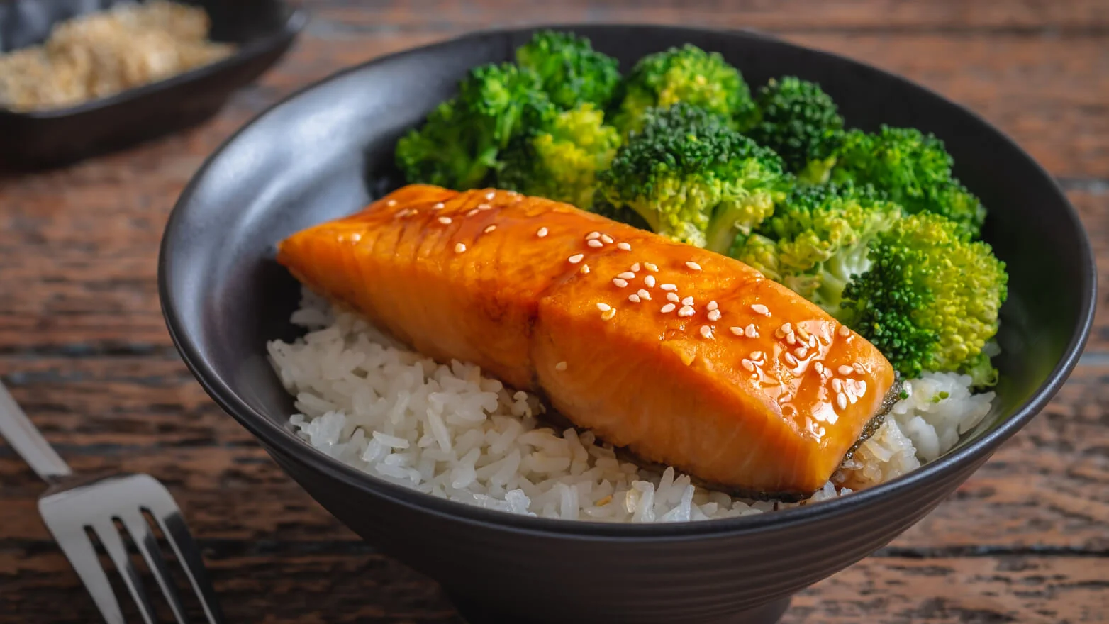 a photo of teriyaki salmon bowls with rice and broccoli