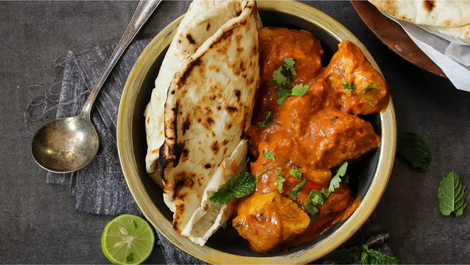 bowl of chicken tikka masala and naan