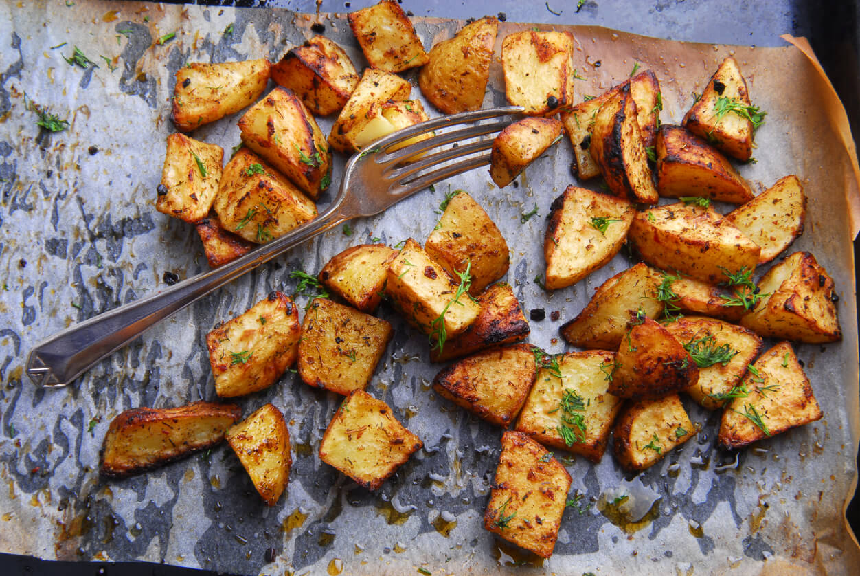 roasted potatoes and fork on baking sheet.
