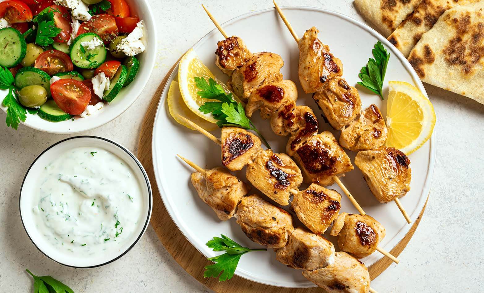Grilled pork souvlaki skewers with tzatziki sauce