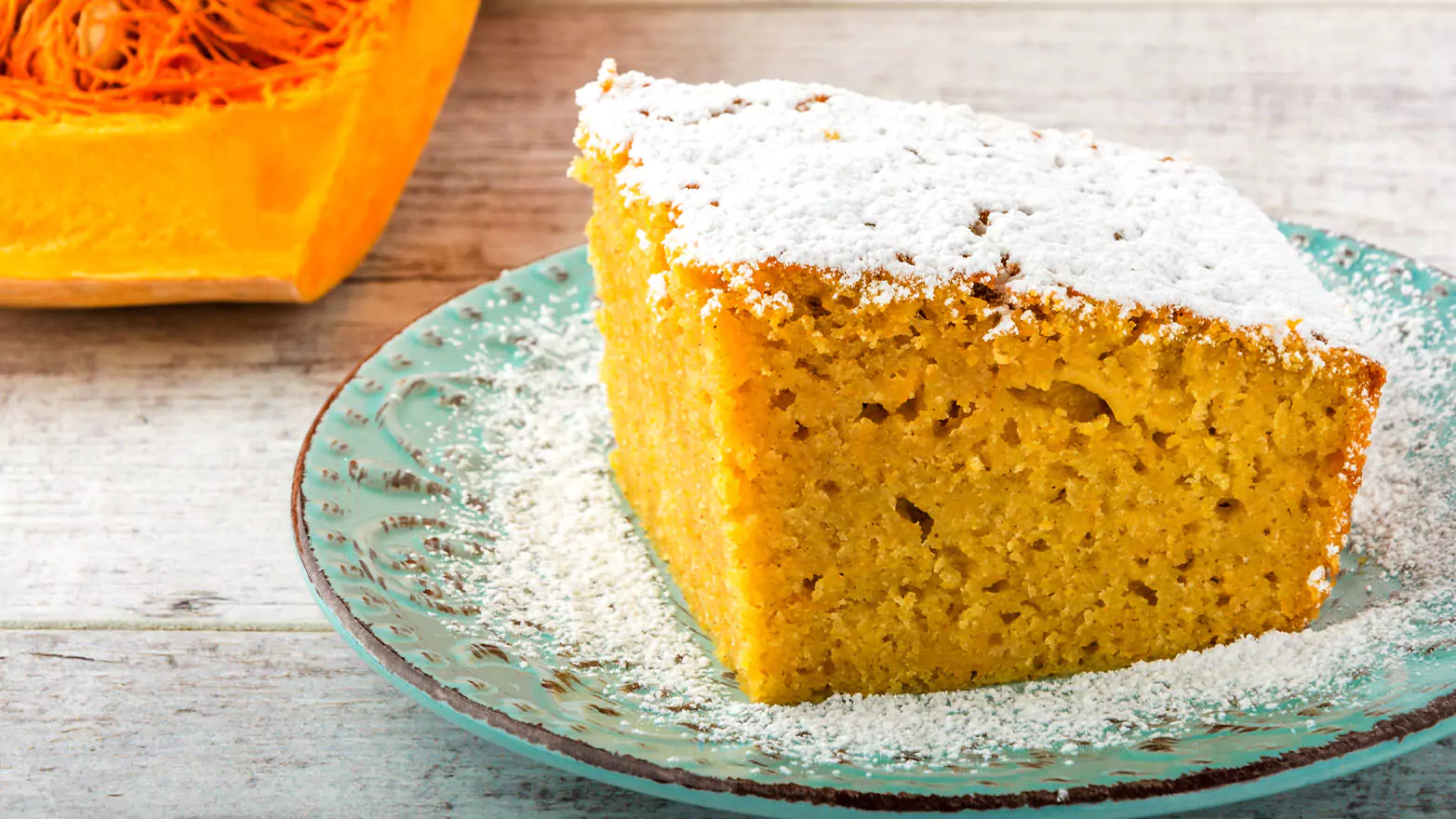 Pumpkin dump cake topped with powdered sugar