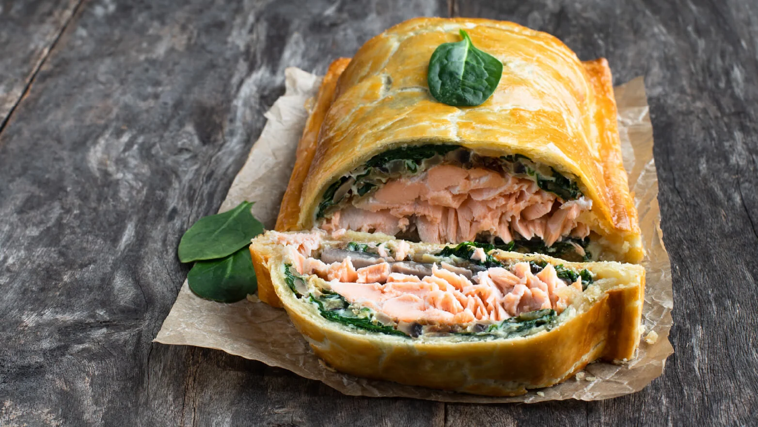 a photo of a puff pastry stuffed with salmon and spinach