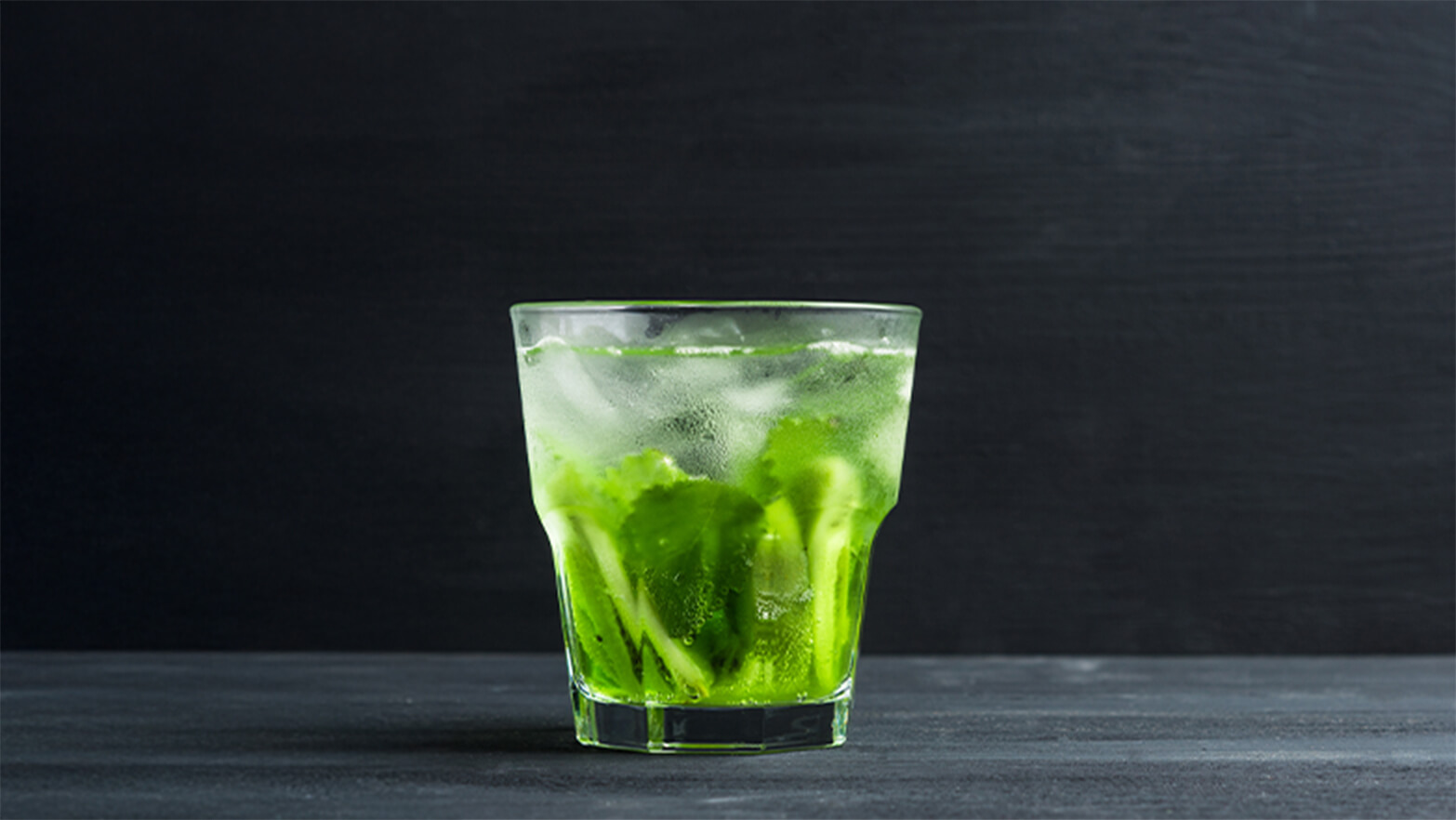 A glass of sparkling green water