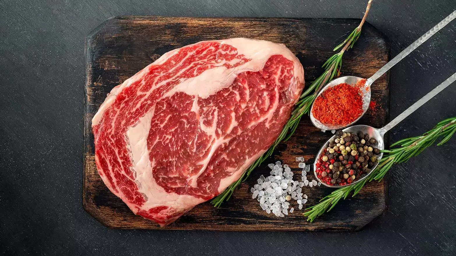 ribeye with fresh herbs and crushed seasoning