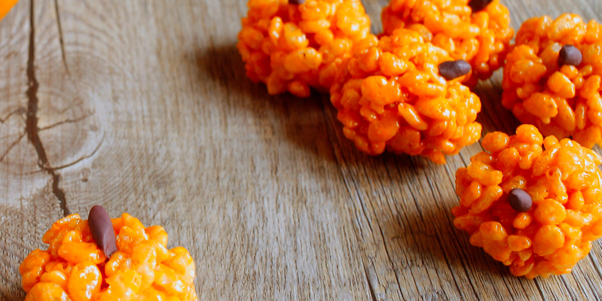 Pumpkin rice krispie treats on a wood table