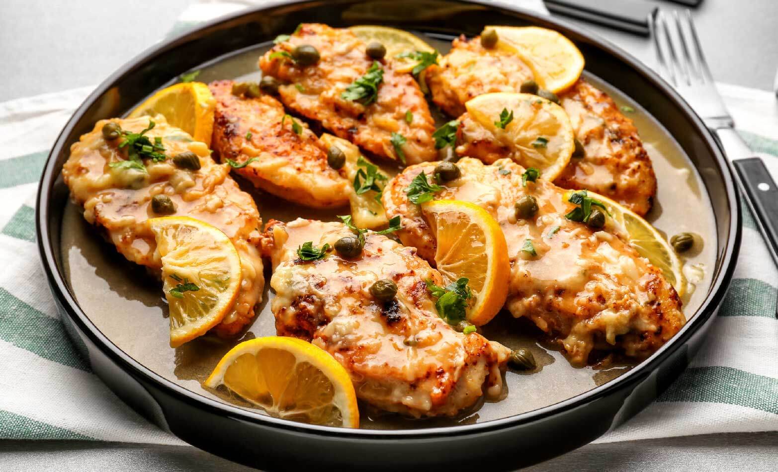 a stock photo of lemon chicken picatta