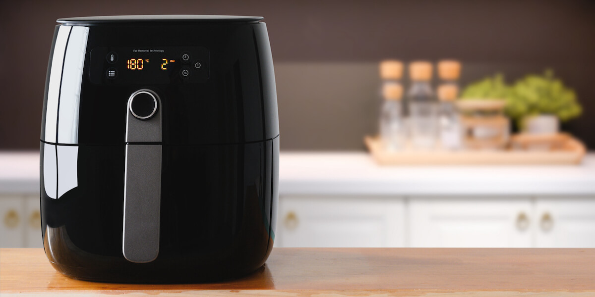 Air fryer machine cooking potato fried in kitchen.