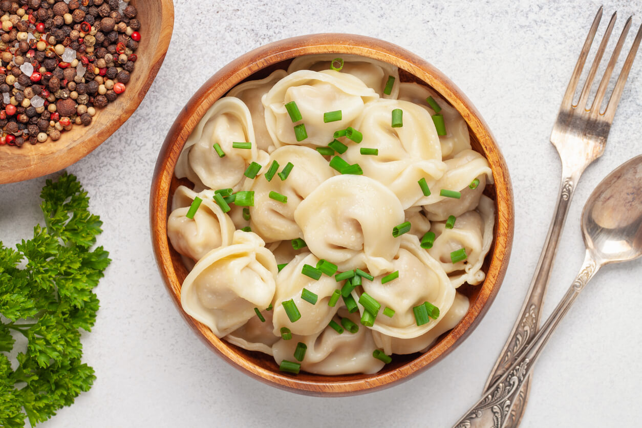 Homemade meat dumplings with onions and parsley- russian pelmeni. 