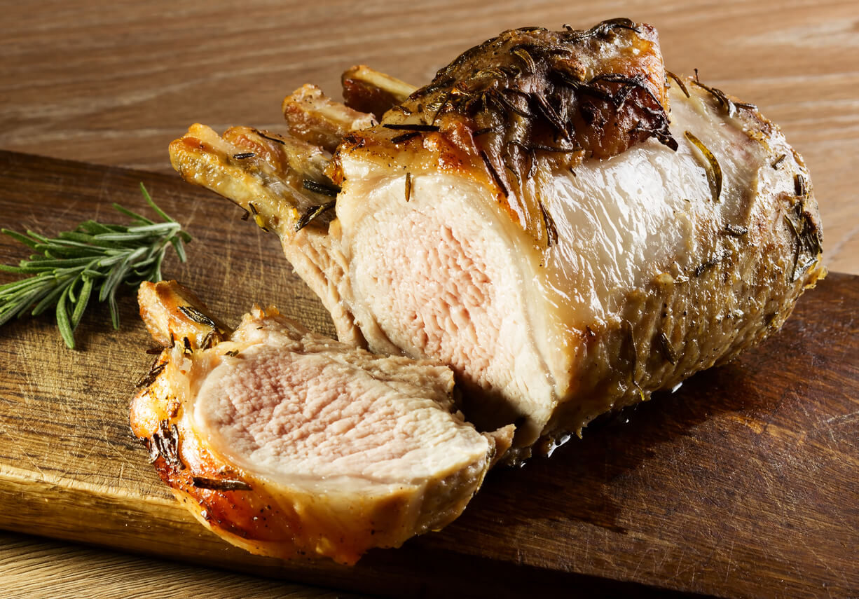 Freshly cooked meat cut up on a cutting board