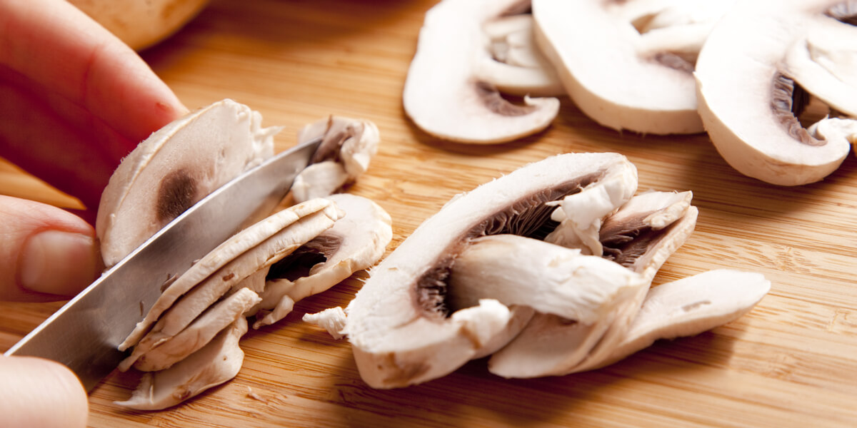 Sliced mushrooms on a cutting board.