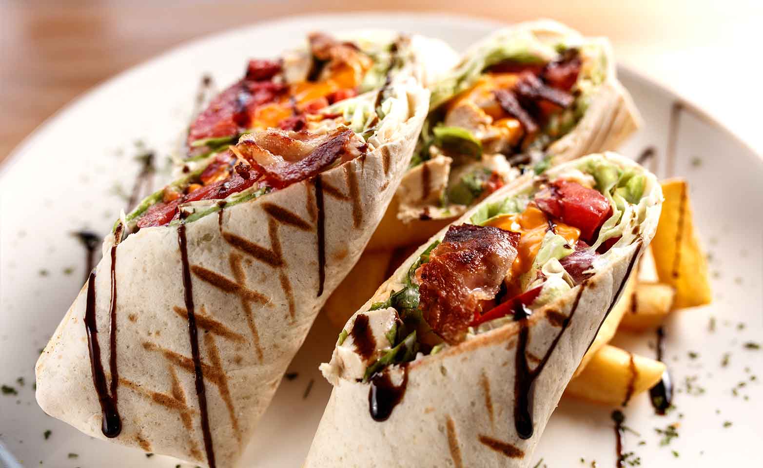 Stock image of grilled turkey bacon wraps