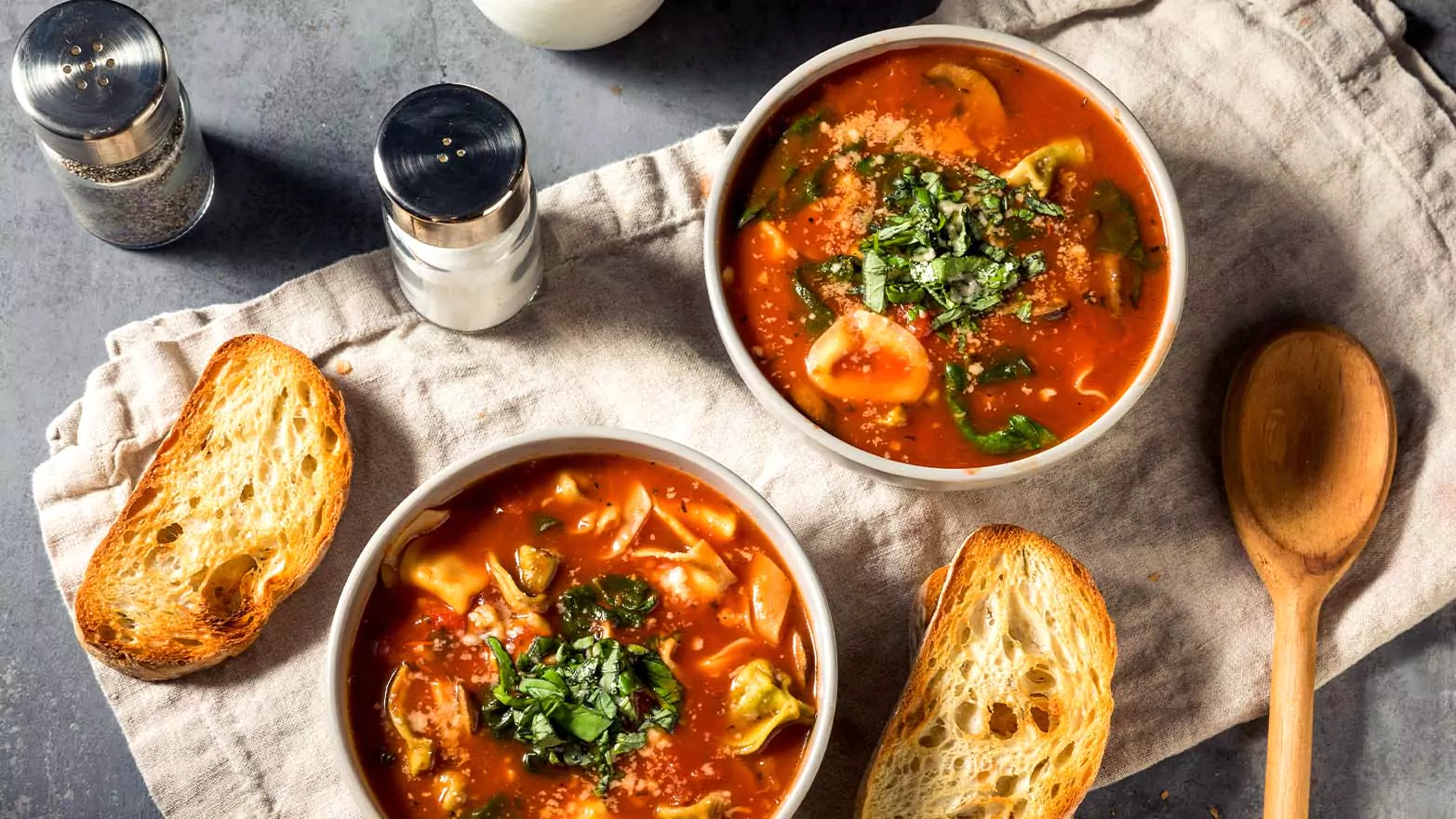 Tortellini soup served with bread.