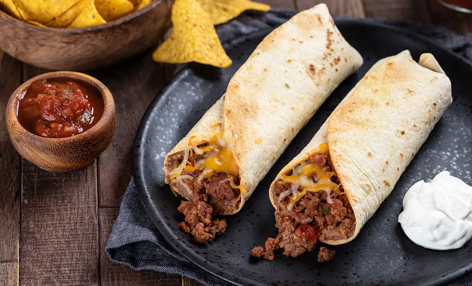 Plated bean and ground beef burritos