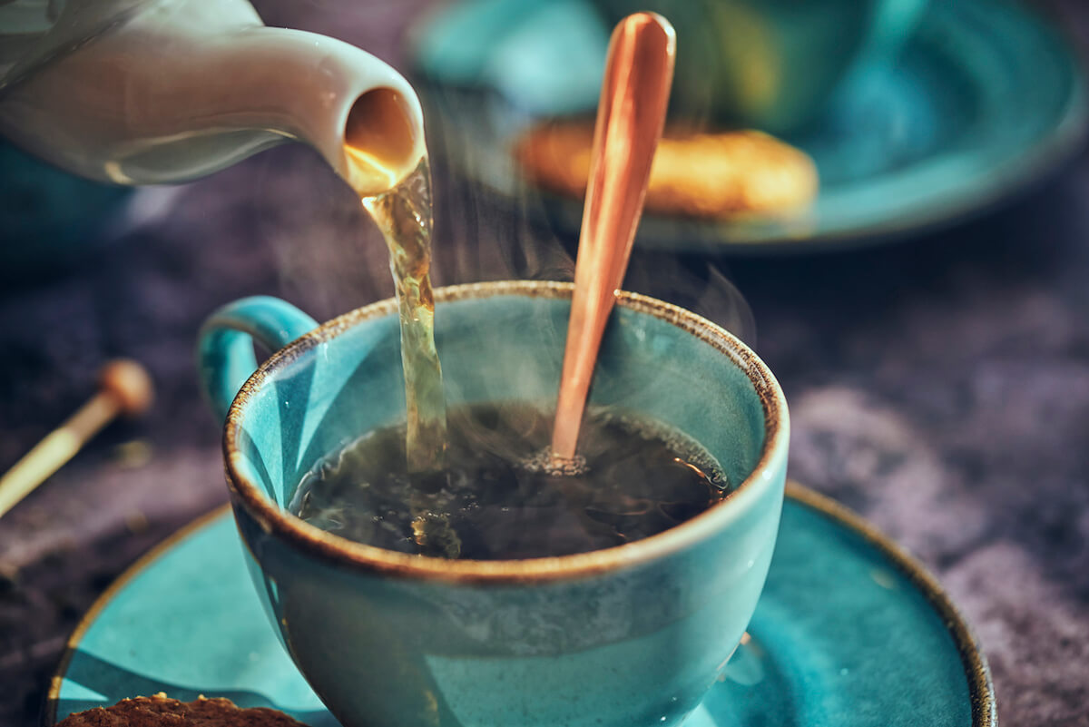 Cup of Black Tea Served with Biscuits