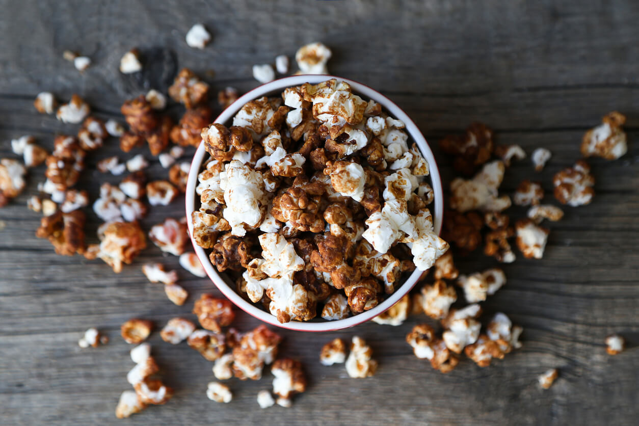 chocolate caramel popcorn on wooden background.